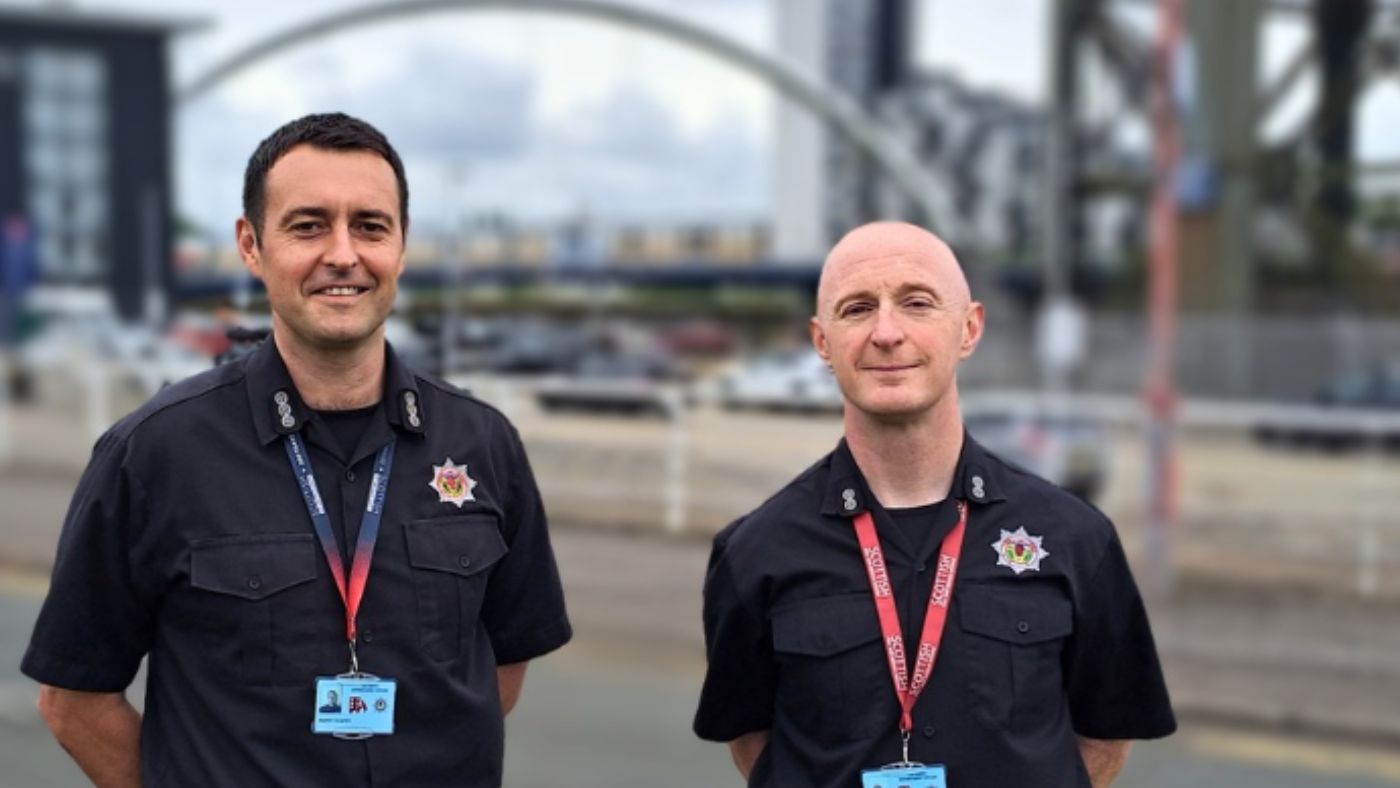 Two fire and rescue service personnel standing in Glasgow near The Hydro