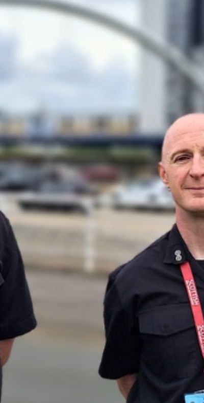 Two fire and rescue service personnel standing in Glasgow near The Hydro