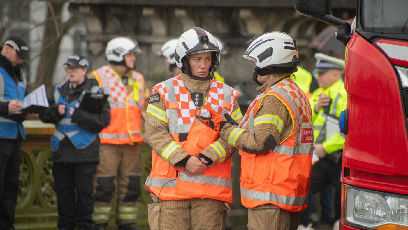 A group of emergency personnel at a rescue scene operation.