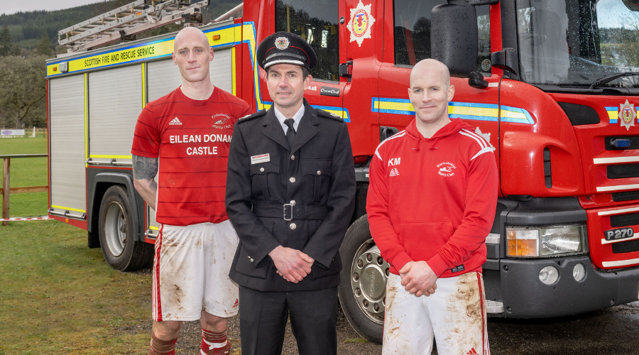 Two shinty players with fire chief 