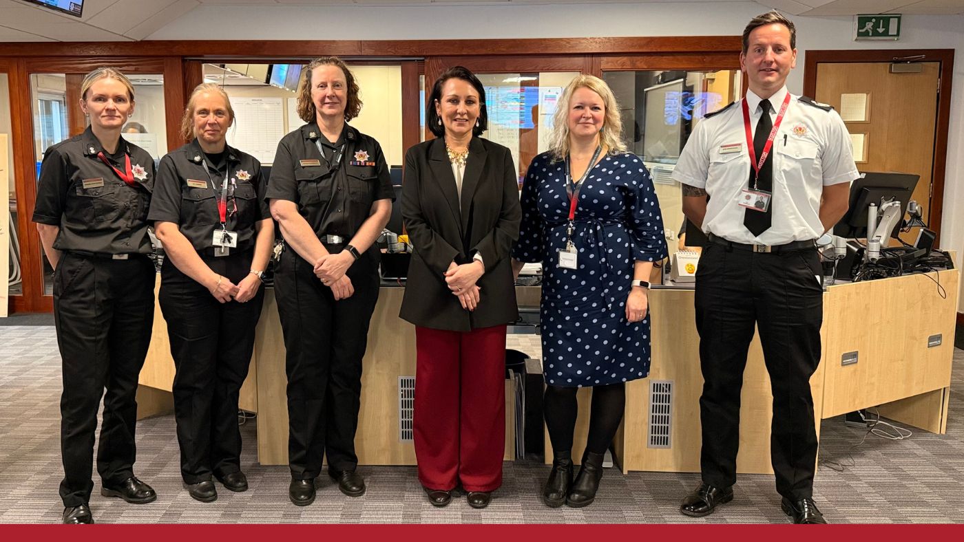 A group of people in looking at the camera and smiling.