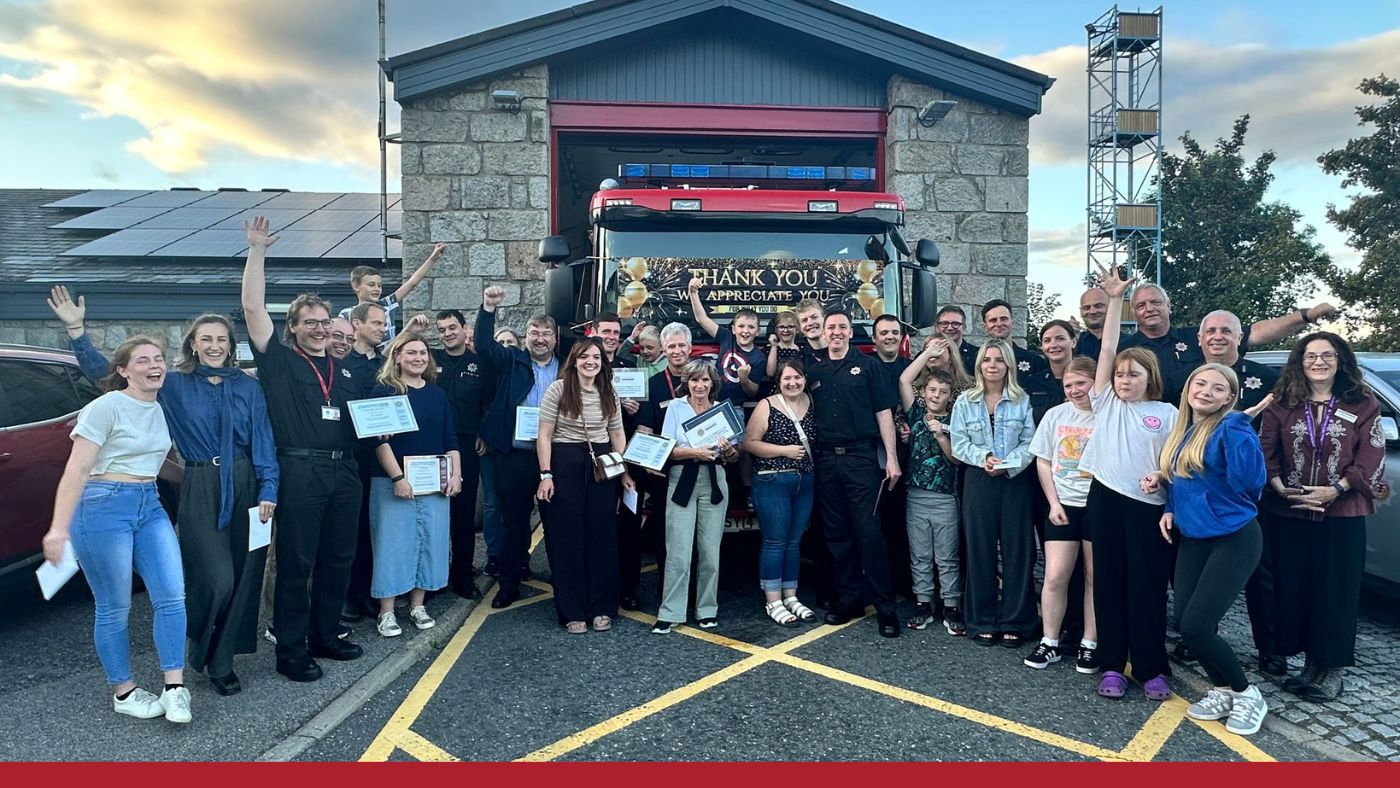 Large group of people outside a fire station
