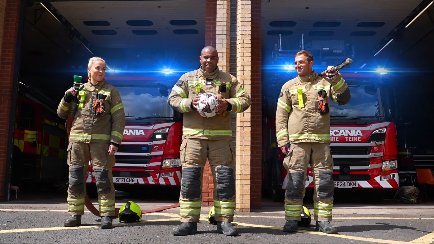 Firefighters with fire engines and football