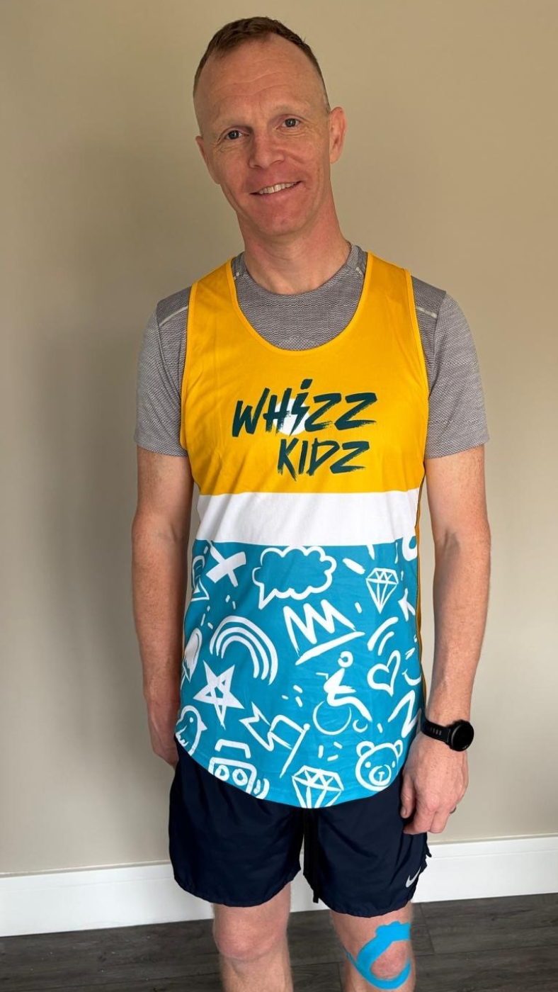 Man in running gear wearing a charity tshirt