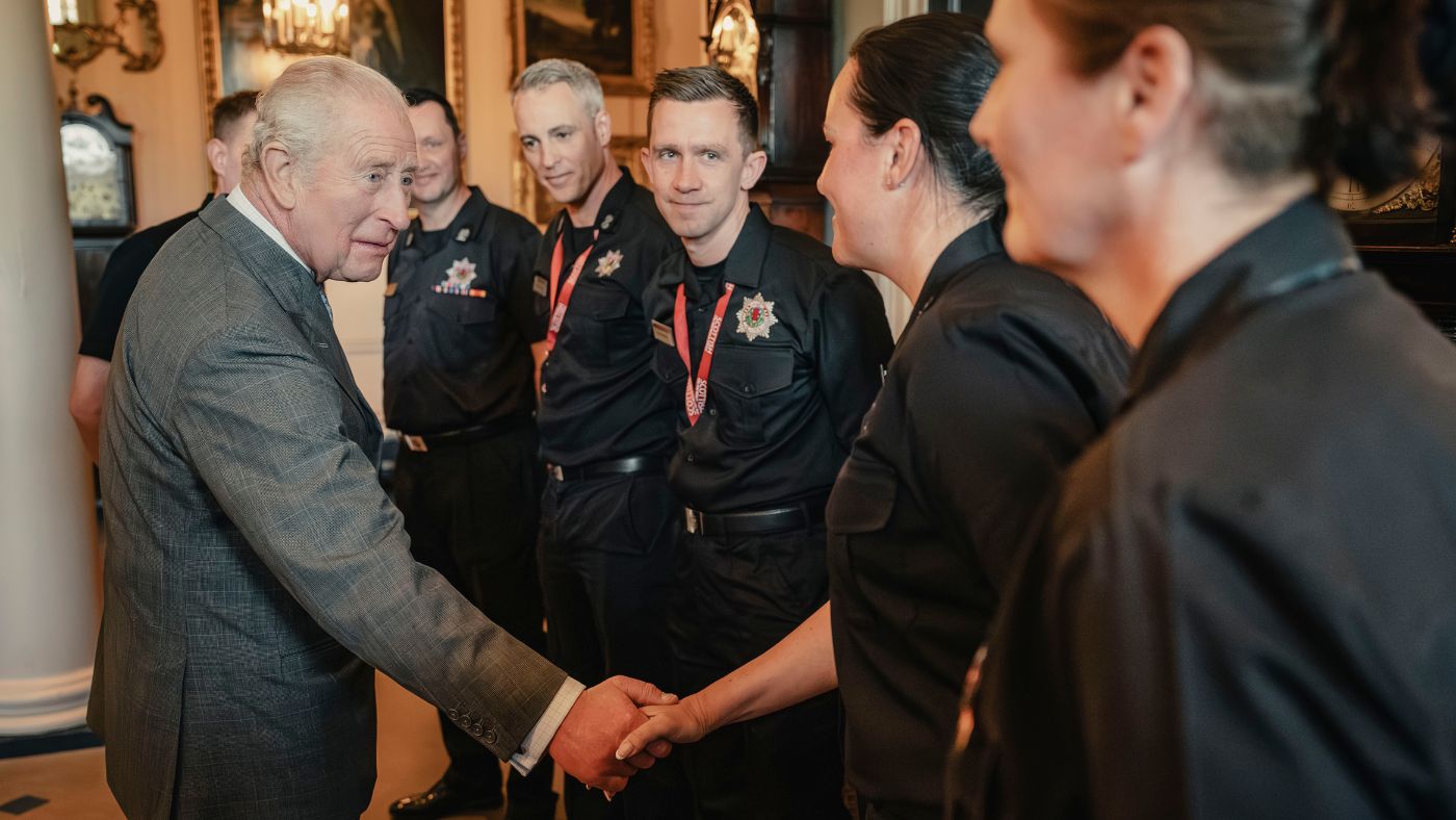 King charles shaking hands with firefighters