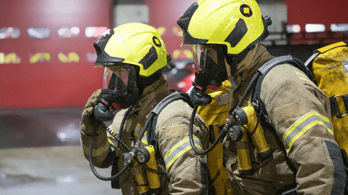 Two firefighters wearing breathing apparatus 